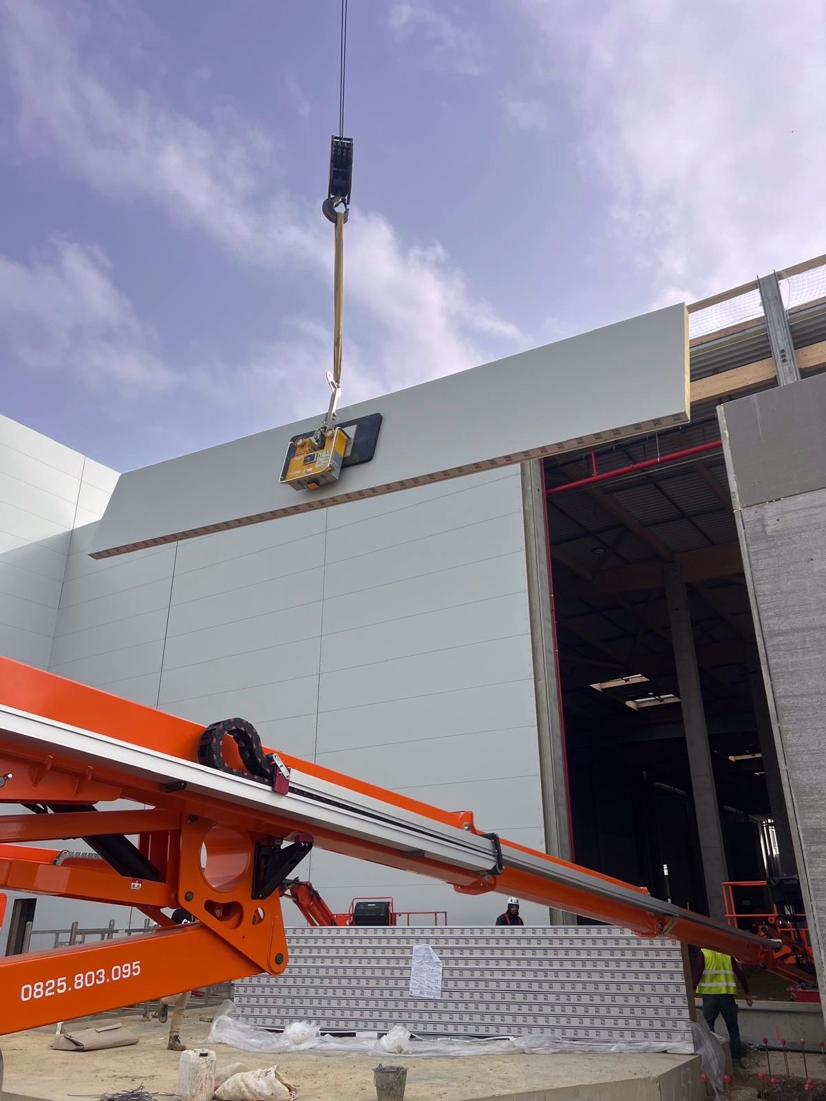 Palonnier à ventouses posant un panneau sandwich sur facade — MTLOC Levage